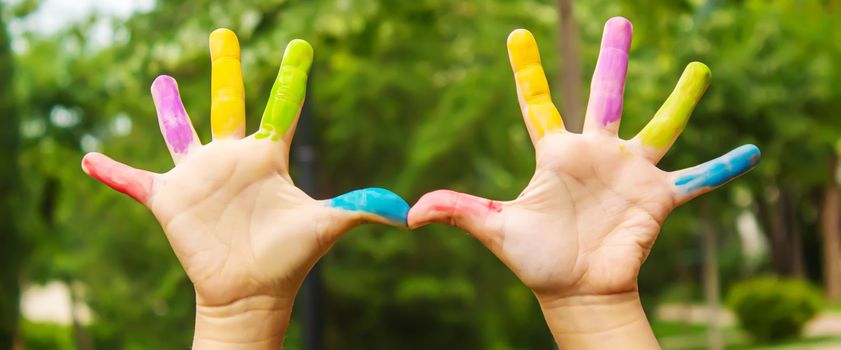 Children's hands in the colors of summer. Selective focus.arts