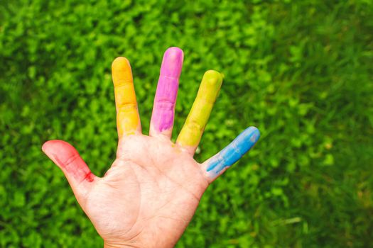 Children's hands in the colors of summer. Selective focus.arts