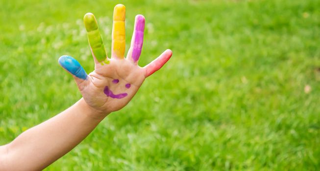 Children's hands in the colors of summer. Selective focus.arts