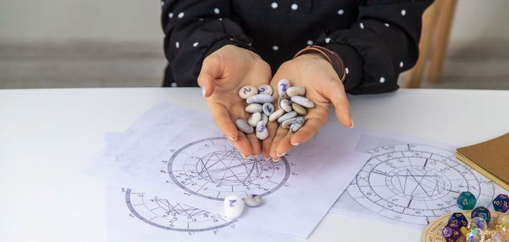 Woman numerologist astrologer counts numbers. Selective focus. People.