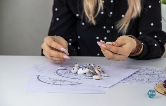 Woman numerologist astrologer counts numbers. Selective focus. People.
