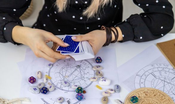 UKRAINE, KYIV - JANUARY 8, 2023. Fortune teller woman reads fortunes on tarot cards. Selective focus.