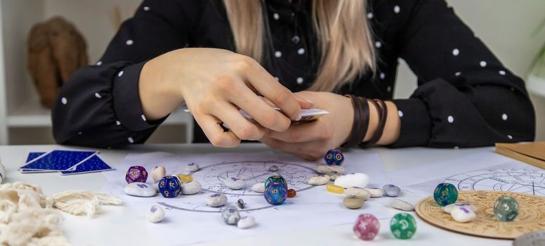 Woman astrologer draws a natal chart. Selective focus. People.
