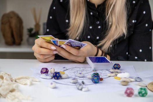Woman astrologer draws a natal chart. Selective focus. People.