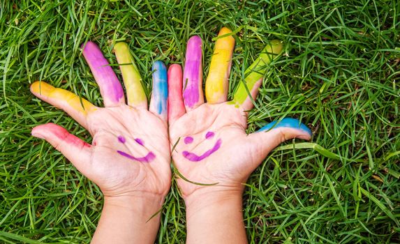 Children's hands in the colors of summer. Selective focus.arts