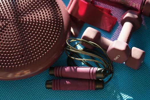 Set of sports accessories jump rope dumbbells and mat. Home workouts and fitness