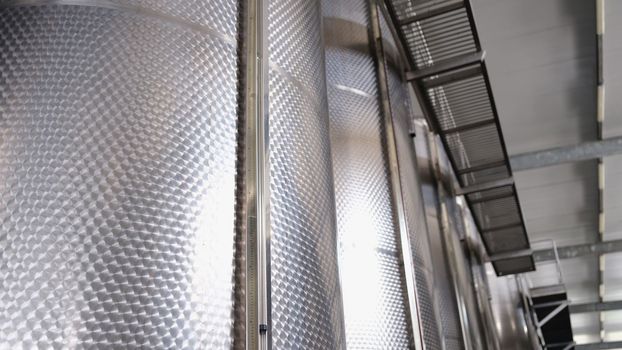Lots of stainless steel tanks modern winery production. Food refining and pharmaceutical chemistry industry.