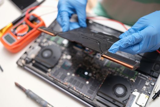 PC repair technician with laptop on background of hardware technologies and computer motherboard. Maintenance engineer support