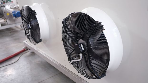 Cooling industrial air conditioners and fans closeup. Maintenance of ventilation systems concept