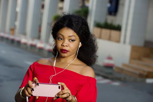Beautiful young woman using laptop on a modern mobile phone with screen to copy text promotional content...