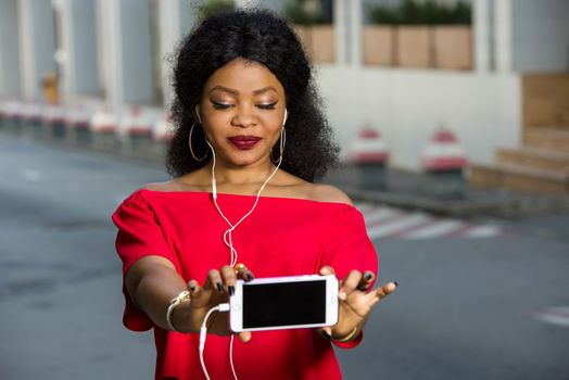 Beautiful young woman using laptop on a modern mobile phone with screen to copy text promotional content...