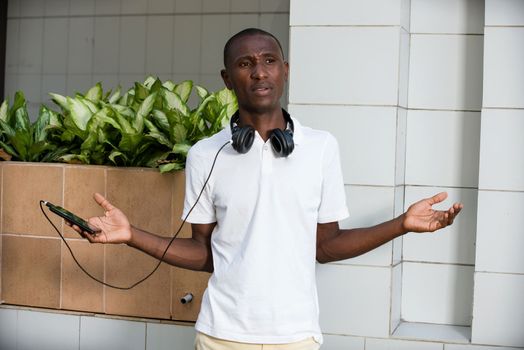 young man wearing a helmet with an expression of surprise standing outside