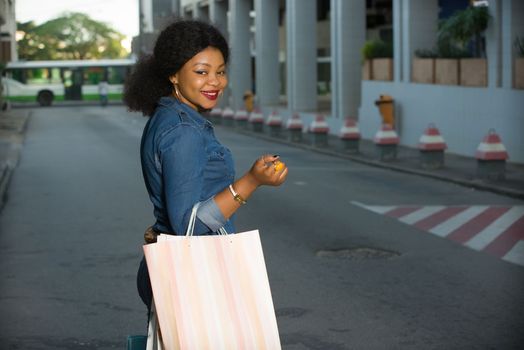 Happy Shopping, beautiful young woman holding bags on the street buying in the city.