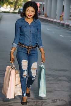 Happy Shopping, beautiful young woman holding bags on the street buying in the city.