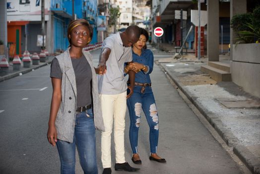 group of young people standing outdoors playing with three.