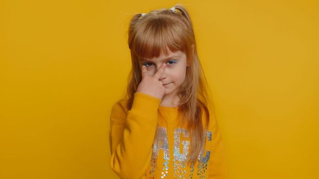 I am watching you. Young preteen child girl kid pointing at her eyes and camera, show I am watching you gesture, spying on someone, see. Female little toddler children isolated on yellow background