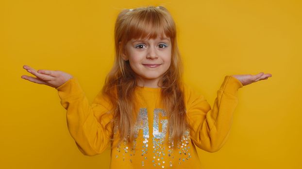 Young preteen child girl kid raising hands in indignant expression, asking why, what reason of failure, demonstrating disbelief irritation by troubles. Little toddler children on yellow background