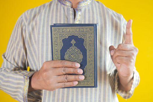 muslim man hand holding Holy book Quran with copy space ,