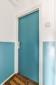 a room with blue walls and white trim on the door, which has been painted in teal's blues