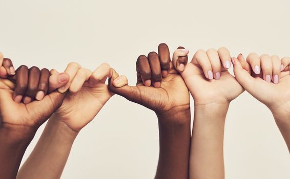 Were stronger together. a group of unrecognizable people holding one anothers thumbs in a single line