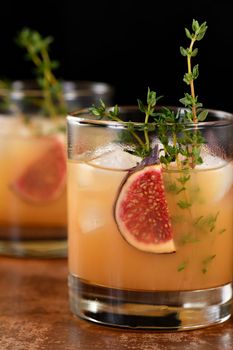 Bourbon Sour cocktail with fig spices, lemon juice and syrup. Easy to make but so delicious. Garnish with figs and thyme.