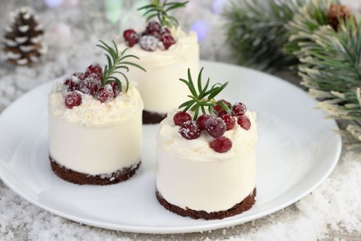 Mousse cakes with coconut cream and Greek yogurt over chocolate cake are the perfect dessert. Add whipped cream and berries. Treat friends and loved ones on Christmas or New Year's Eve