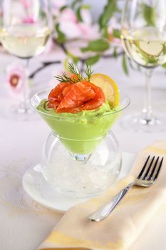 Taste is a combination of avocado pulp with a delicate texture of soft  cheese cream and salmon, with the addition of dill and a slice of lemon. Serving verrine in a Martini Chiller with ice. Aperitif appetizer