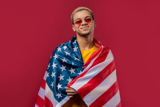 Happy man with national USA flag on red background. American patriot, 4th of July - Independence day celebration, election, America, labor. US banner. High quality photo
