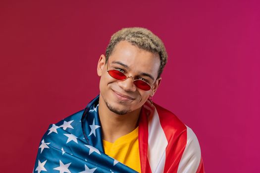 Happy man with national USA flag on red background. American patriot, 4th of July - Independence day celebration, election, America, labor. US banner. High quality photo