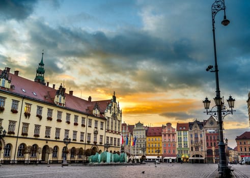 Wroclaw market square full of old colorful tenement houses at cloudy morning
