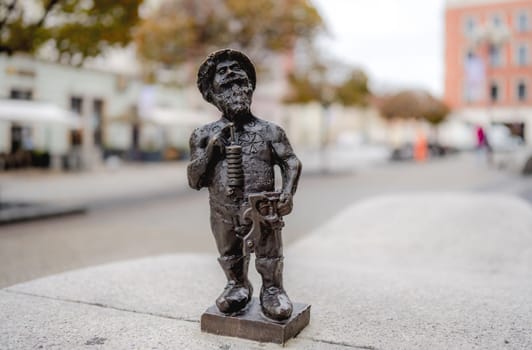 Sculpture of a dwarf made of copper, the symbol of Wroclaw. Tourist adventure Dwarf hunt in Wroclaw. Scattered throughout the city are many mini gnome statues