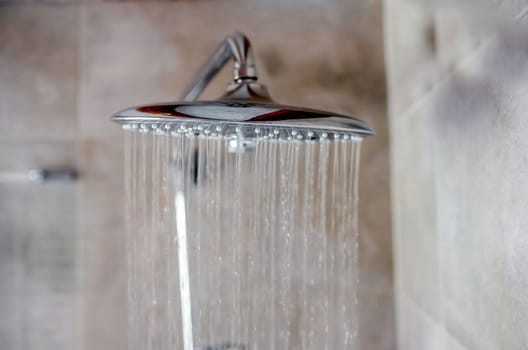 Fresh shower with water drops splashing. Water running from shower head