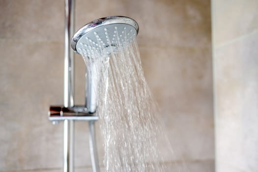 Fresh shower with water drops splashing. Water running from shower head