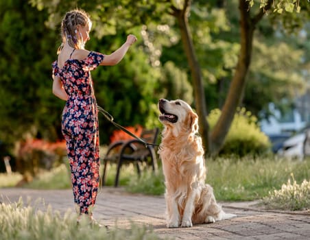 Preteen girl and her golden retriever dog on lace looking at camera. Female child kid with a purebred labrador doggy pet