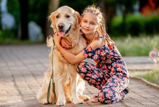 Preteen girl and her golden retriever dog on lace looking at camera. Female child kid with a purebred labrador doggy pet