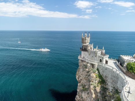 Aerial view of Swallow's Nest castle on the rock in Black Sea. It is a symbol and landmark of Crimea. Beautiful scenic panorama of the Crimea coast. Amazing Swallow's Nest at the precipice.