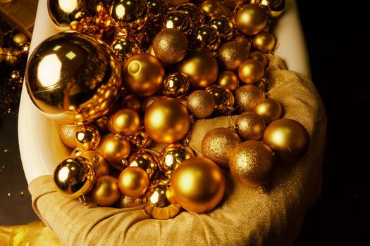 Bathtub full of golden balls. Vintage bright bathroom decorated with festive golden balls. New Year, Christmas bathroom interior