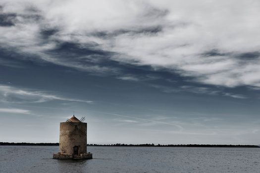 Windmill in the Orbetello lagoon , symbol of the city ,circular shape with conical roof