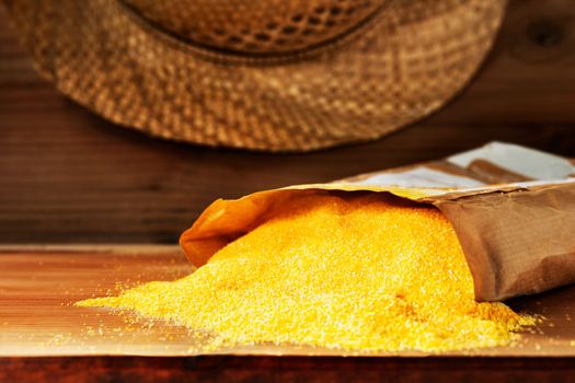  Yellow grains of cornmeal , polenta in bag on wooden table, Italian traditional food