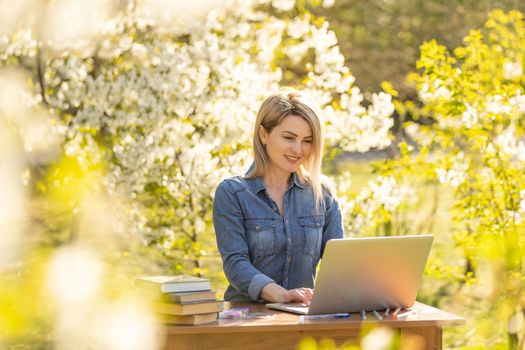 attractive woman using laptop in the park