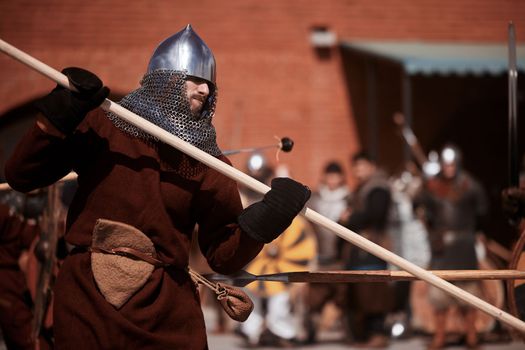 Warrior with a spear in medieval dress. Warrior of medieval Europe. Medieval battle - Historical reconstruction. Medieval tournament. 14.05,2022. Yoshkar-Ola, Russia