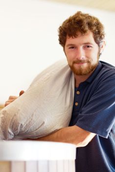 Following the family recipe. a man adding ingredients to a tun in a brewery