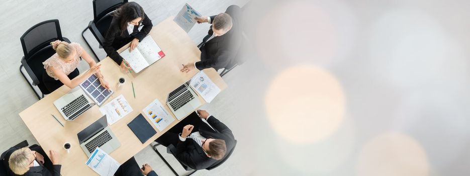 Business people group meeting shot from top widen view in office . Profession businesswomen, businessmen and office workers working in team conference with project planning document on meeting table .