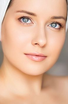 Skin care and beauty routine, beautiful woman with white towel wrapped around head, skincare cosmetics and face cosmetology, close-up portrait