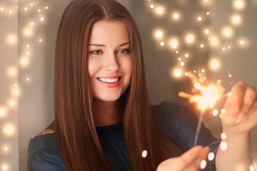 Holiday magic, Christmas and New Year celebration, happy woman with sparklers, portrait