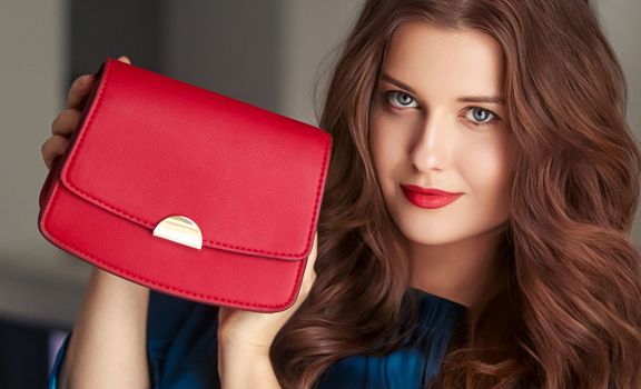 Fashion and accessories, happy beautiful woman holding small red handbag with golden details as stylish accessory and luxury shopping concept