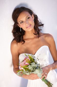 Romantic bridal style. Beautiful young bride holding her bouquet