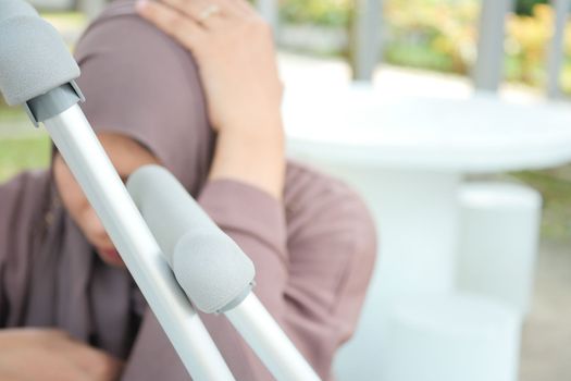 upset young women with broken leg on crutches