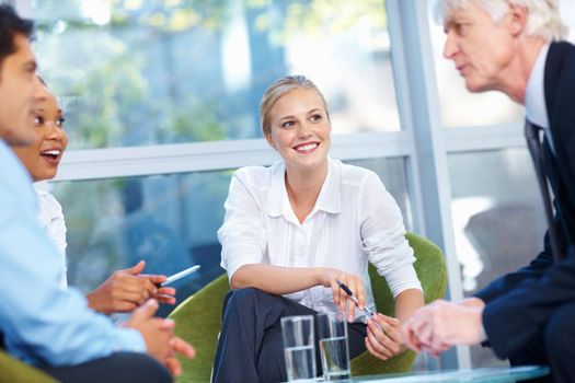 Business people having happy discussion. Portrait of successful business people having discussion at office