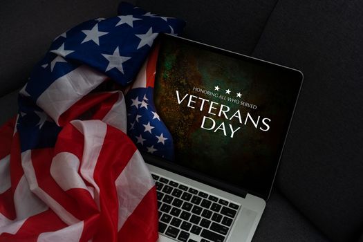 veterans day written in laptop with flag of the United States